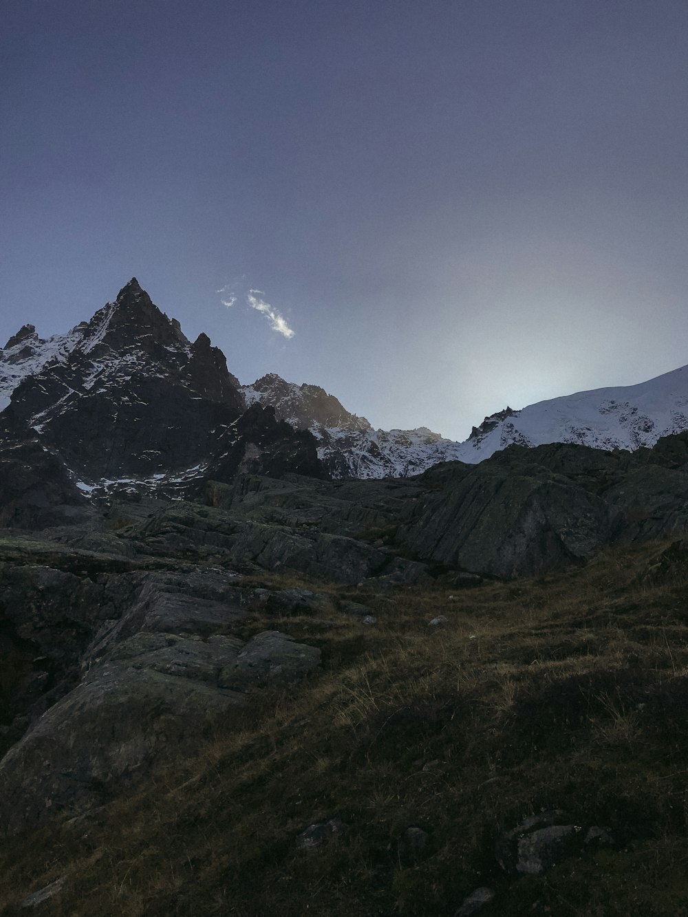 a mountain range with snow covered mountains in the background