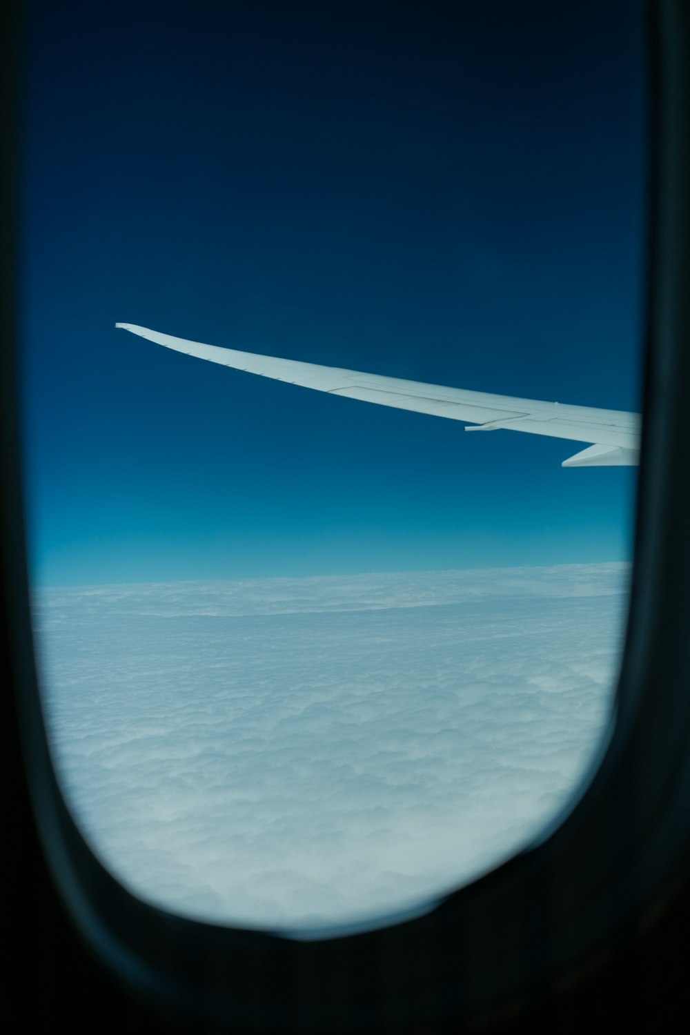 the wing of an airplane flying above the clouds