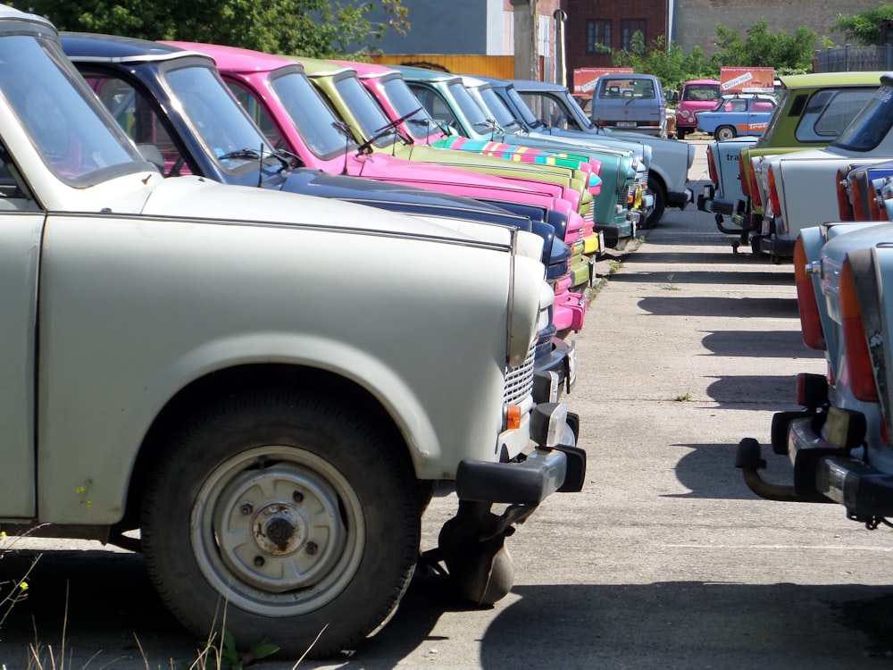 a row of parked cars sitting next to each other