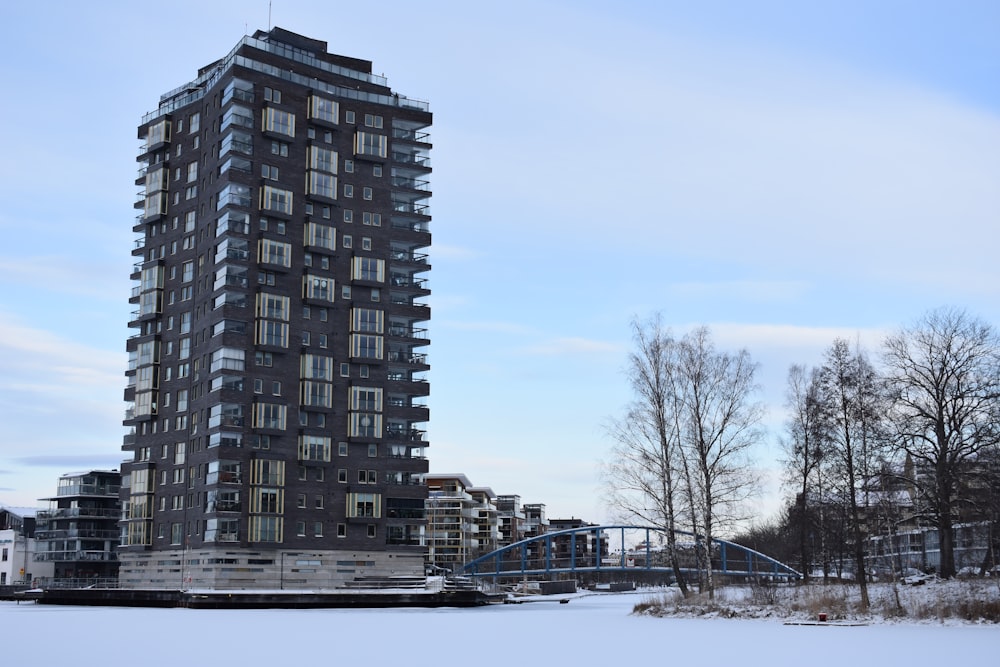 a very tall building sitting next to a bridge