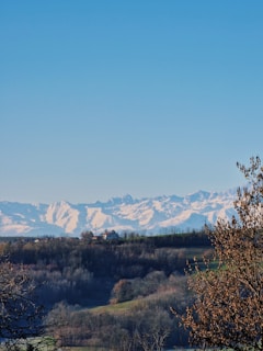 A panoramic view of the sprawling multi-acre homesites nestled beneath towering mountain peaks dusted with snow.