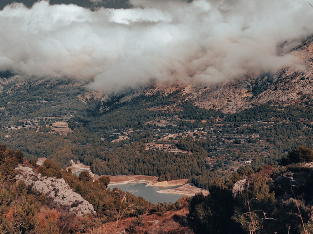 a view of a mountain range with a lake in the foreground