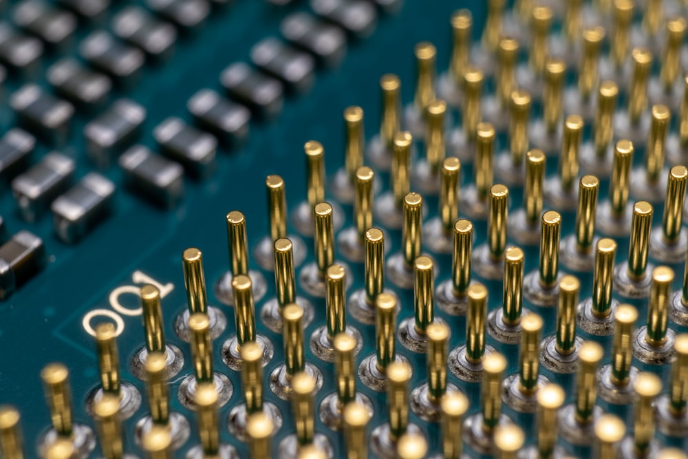 a close up of a computer board with many screws