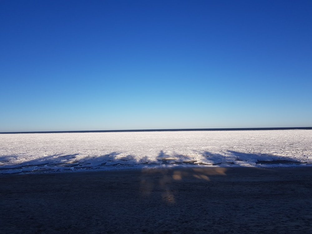 the shadow of a person standing in the snow