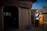 A happy couple standing in front of their new Jaipur home with traditional architecture.