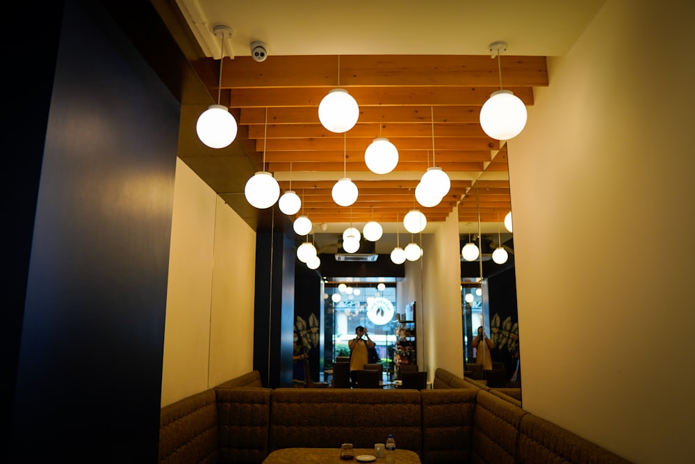 a room with a lot of lights hanging from the ceiling