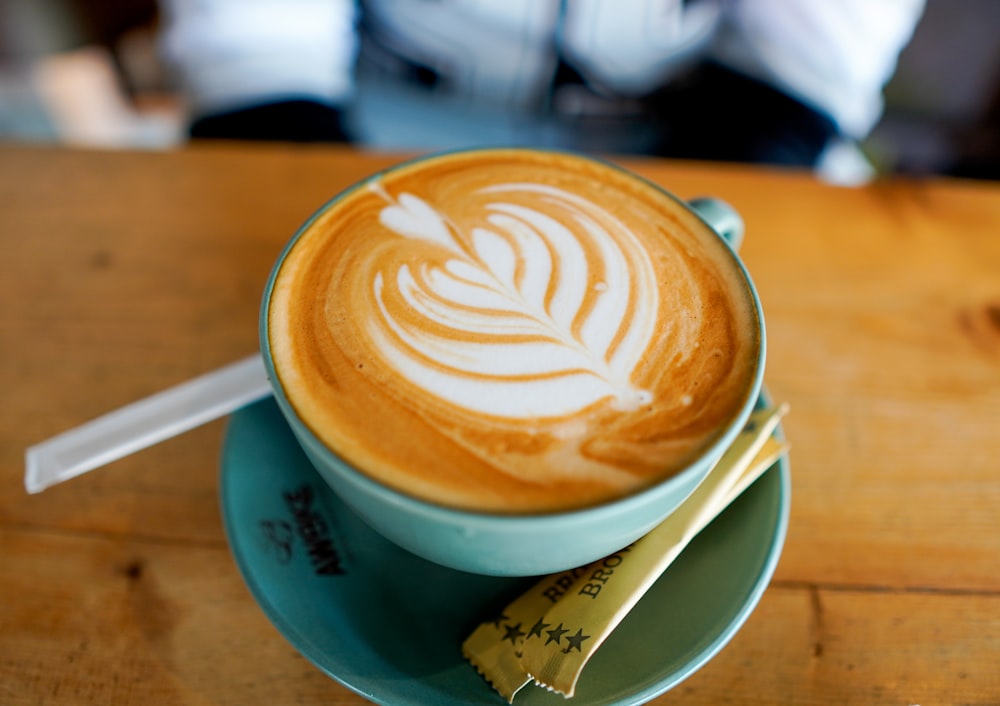 a cappuccino on a saucer with a measuring tape