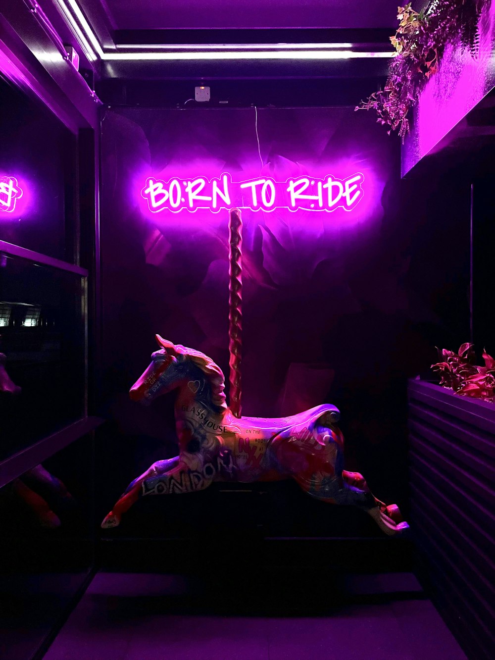 a neon sign that reads born to ride