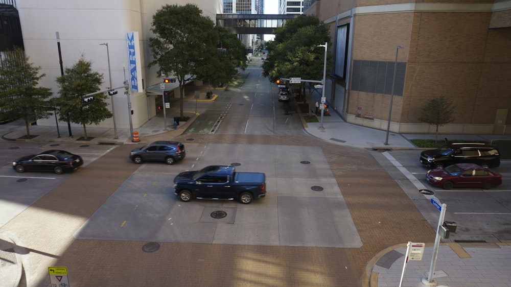 a view of a city street with cars driving down it