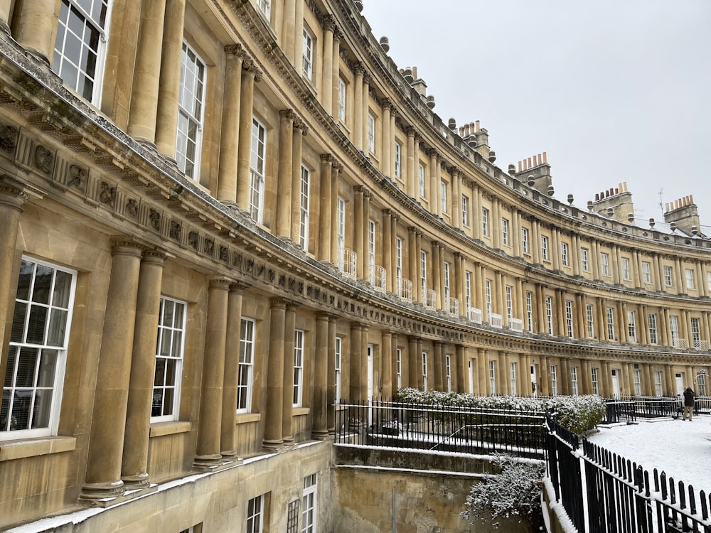 a row of buildings with snow on the ground