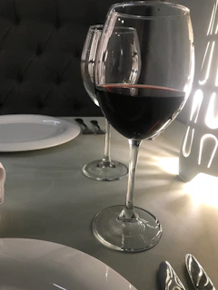 Elegant wine glasses filled with red and white wine at a cozy dinner setting