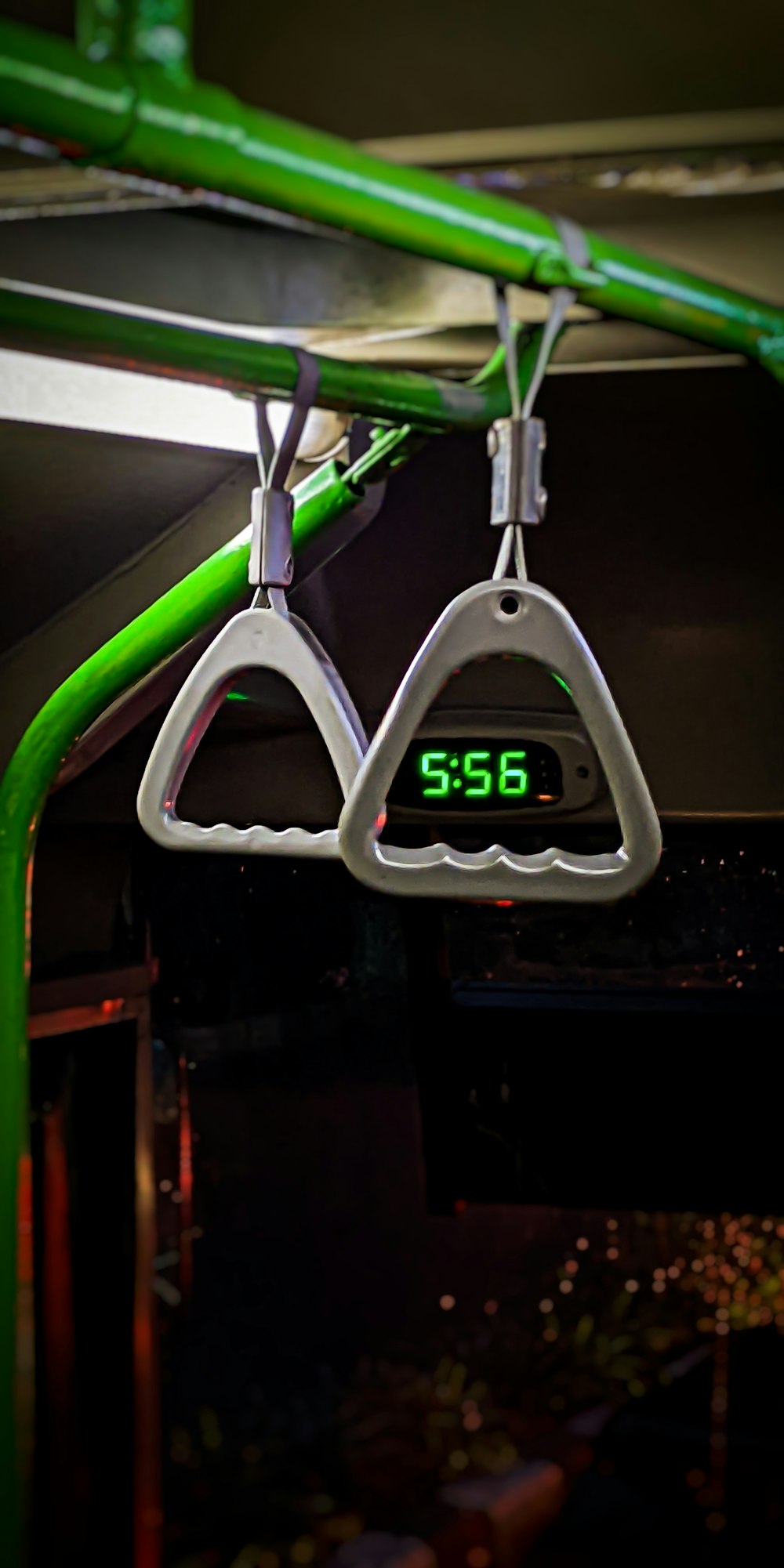 a green and white clock hanging from the ceiling