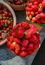 A vibrant display of fresh strawberries on a wooden table.