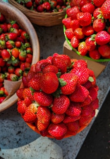Bunches of juicy grapes and vibrant strawberries displayed on a rustic wooden table.