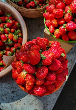 A vibrant display of fresh strawberries on a wooden table.