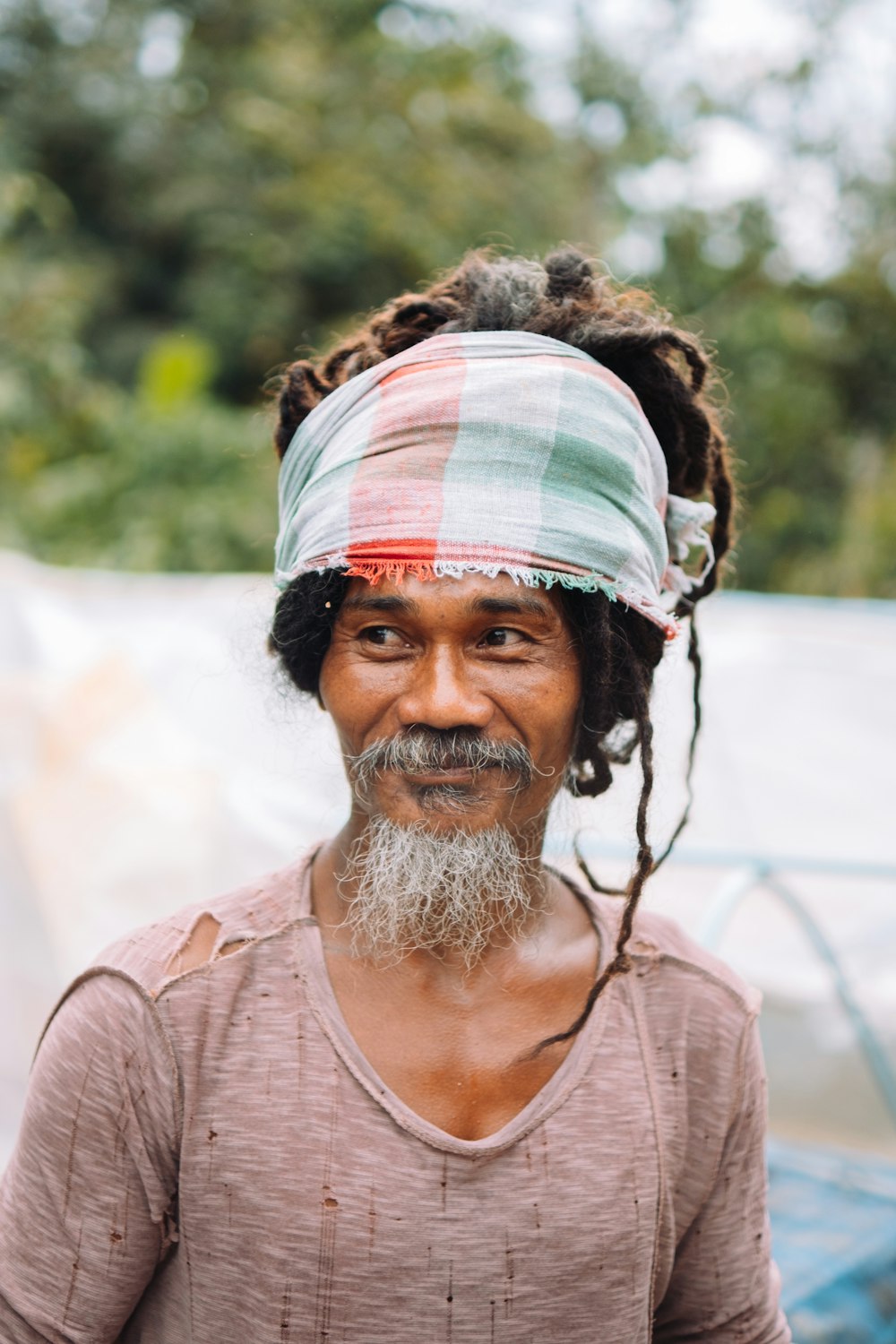 a man with dreadlocks and a bandana on his head