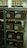A set of metal shelves filled with cardboard boxes, each labeled with handwritten notes. The shelves are located in a storage area, possibly a warehouse or archive, with additional boxes in the background. The lighting is dim, creating a somewhat shadowy environment.
