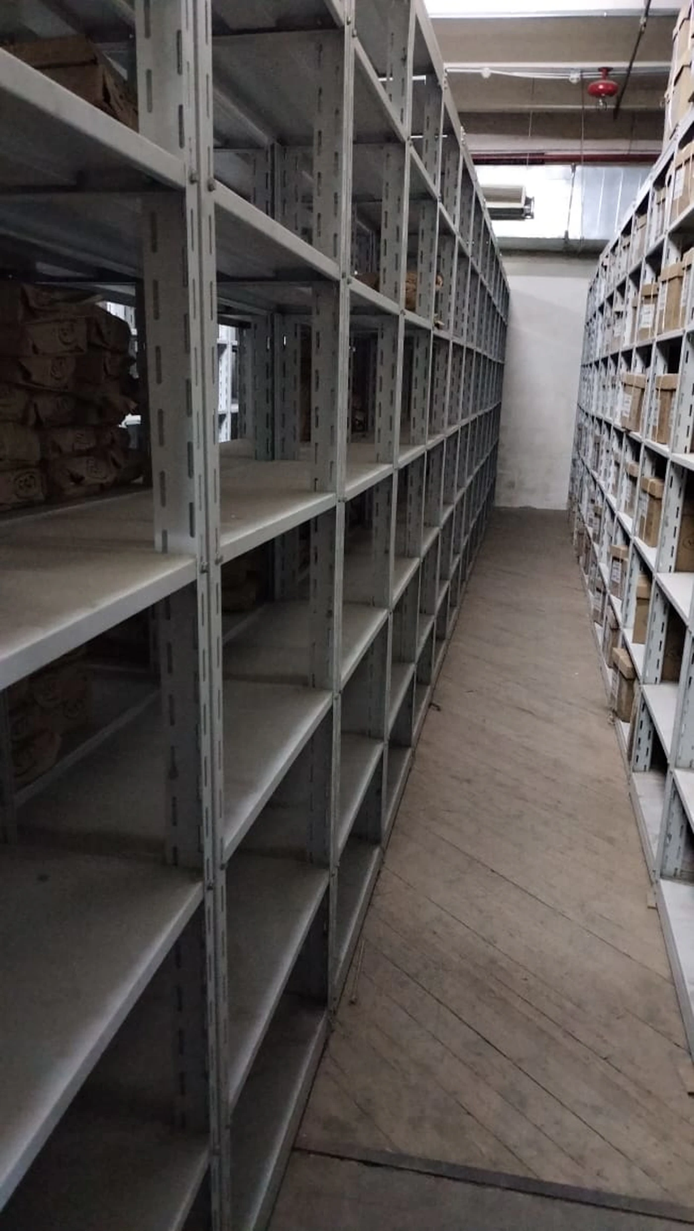 Reference image of organised warehouse shelving and boxed stock