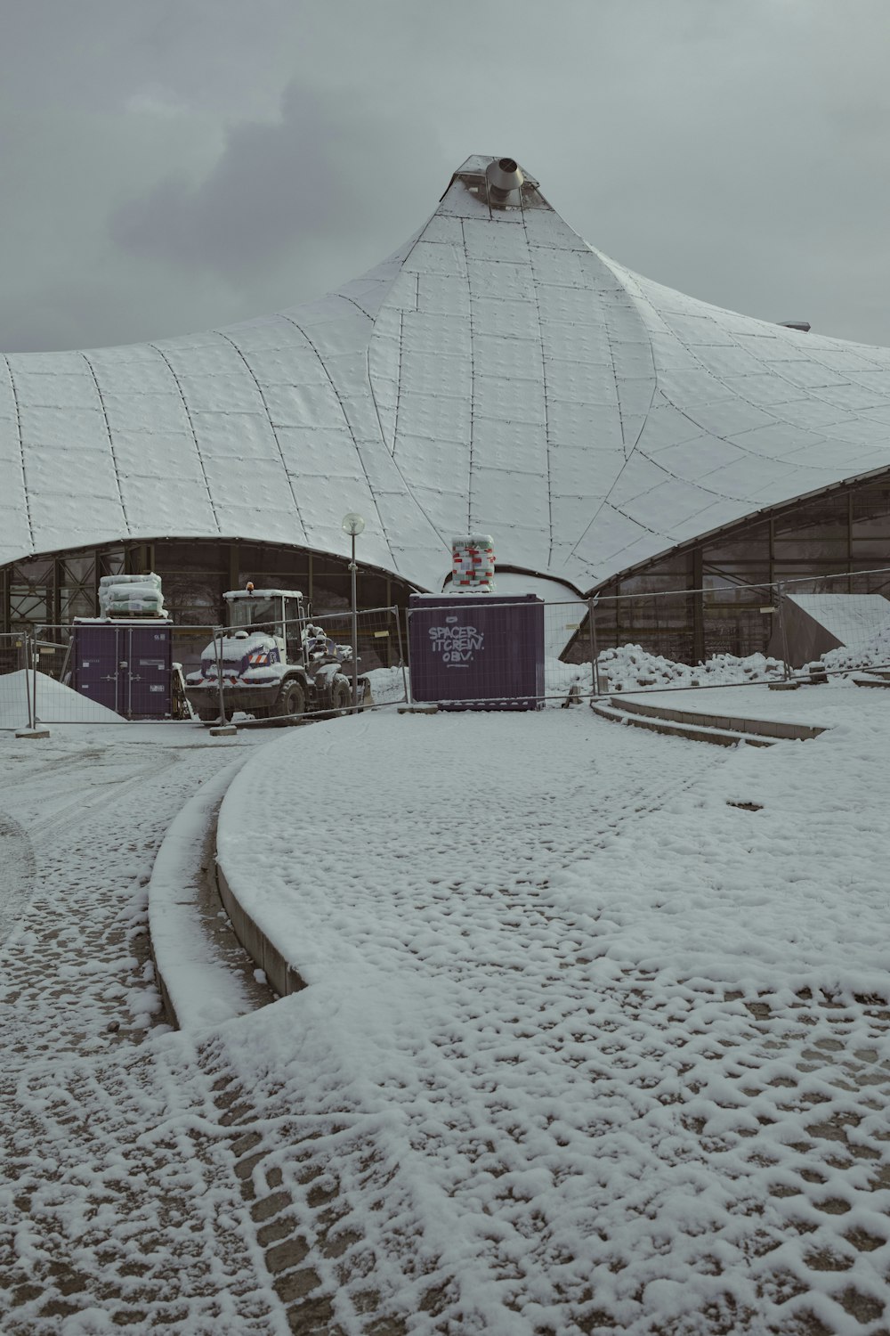 a building with a large white roof covered in snow