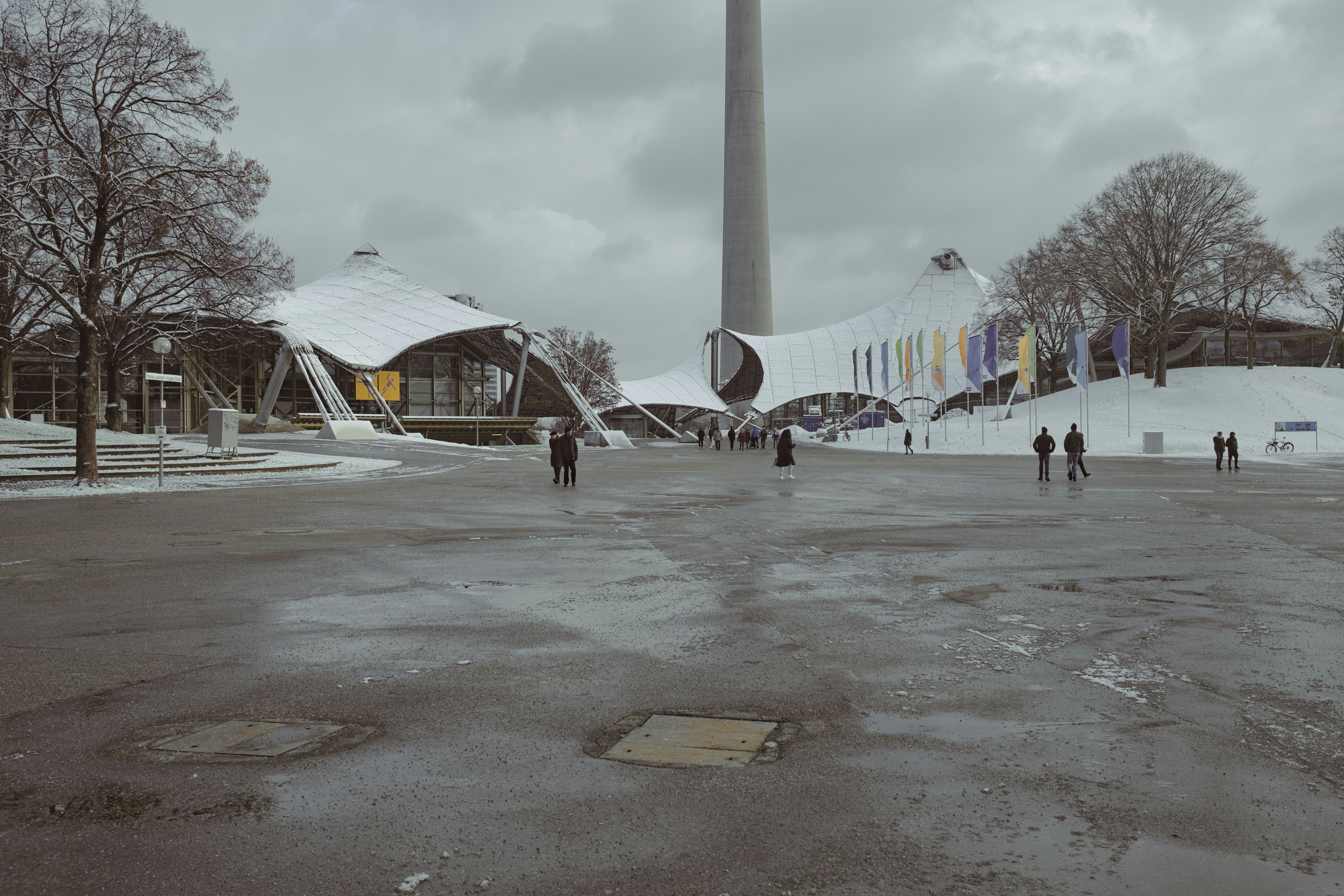 a group of people walking around a parking lot