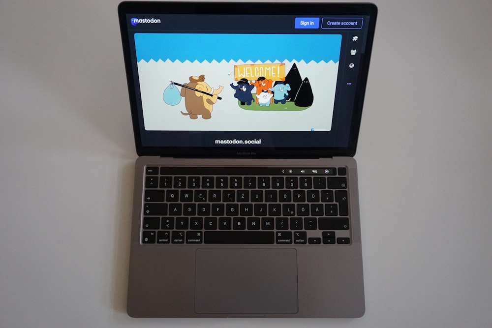 a laptop computer sitting on top of a white table