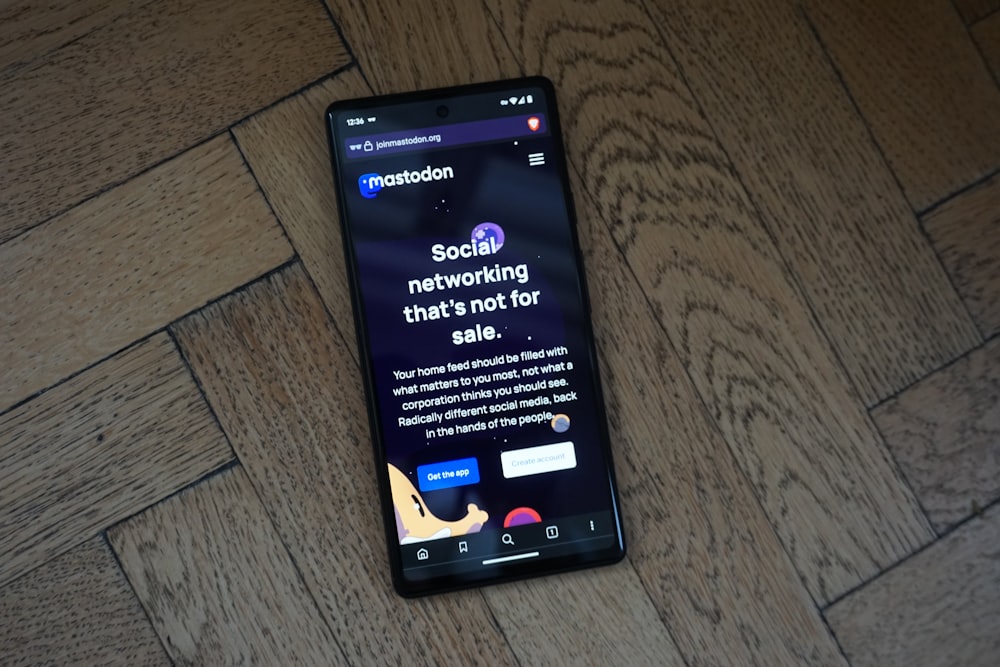 a cell phone sitting on top of a wooden floor