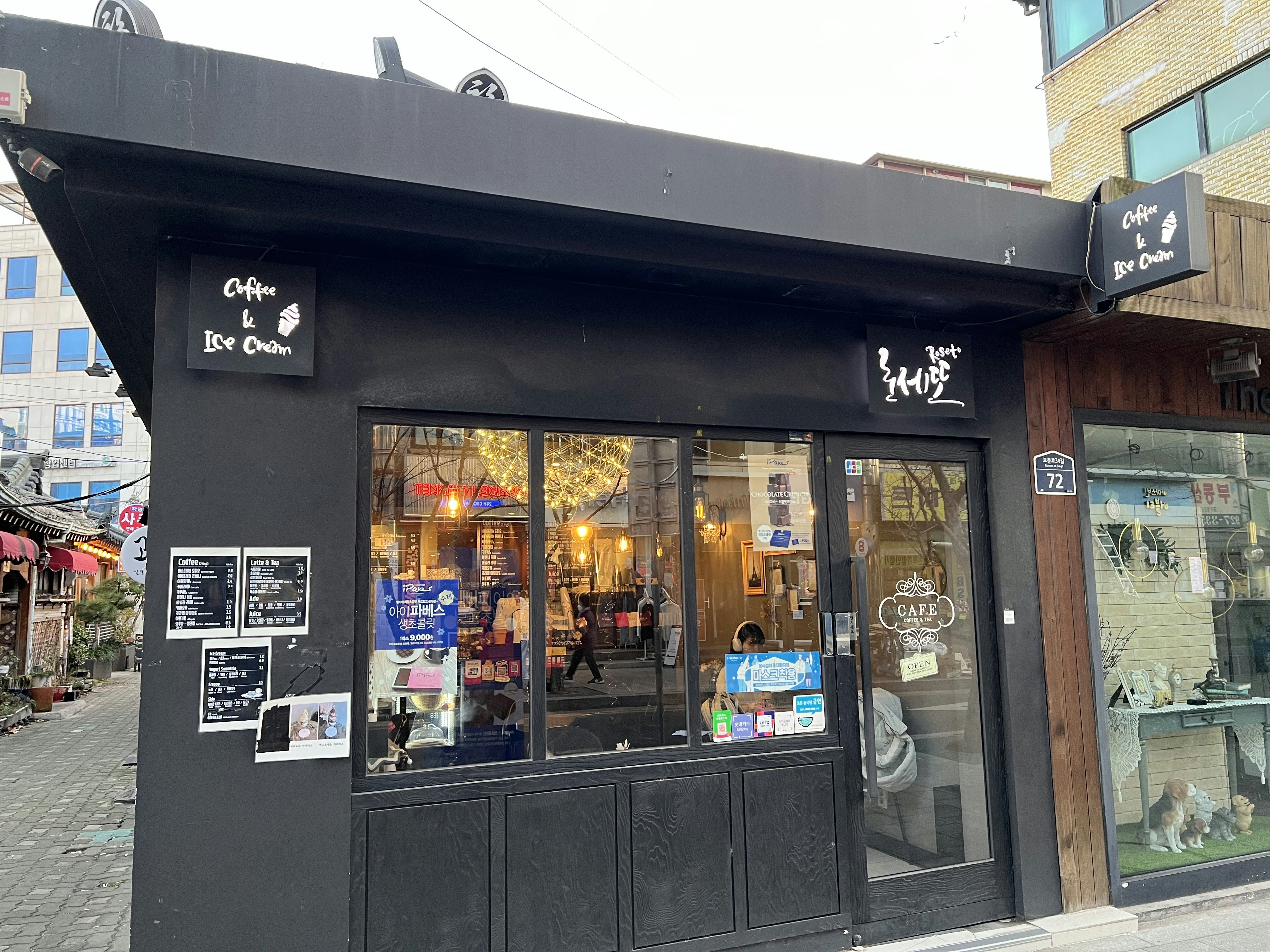 a black store front with many signs on it