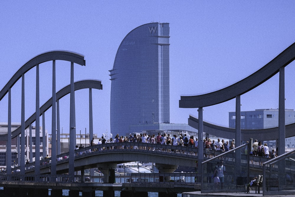 a group of people walking across a bridge