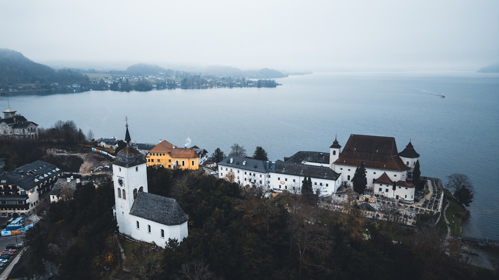 an aerial view of a town by the water