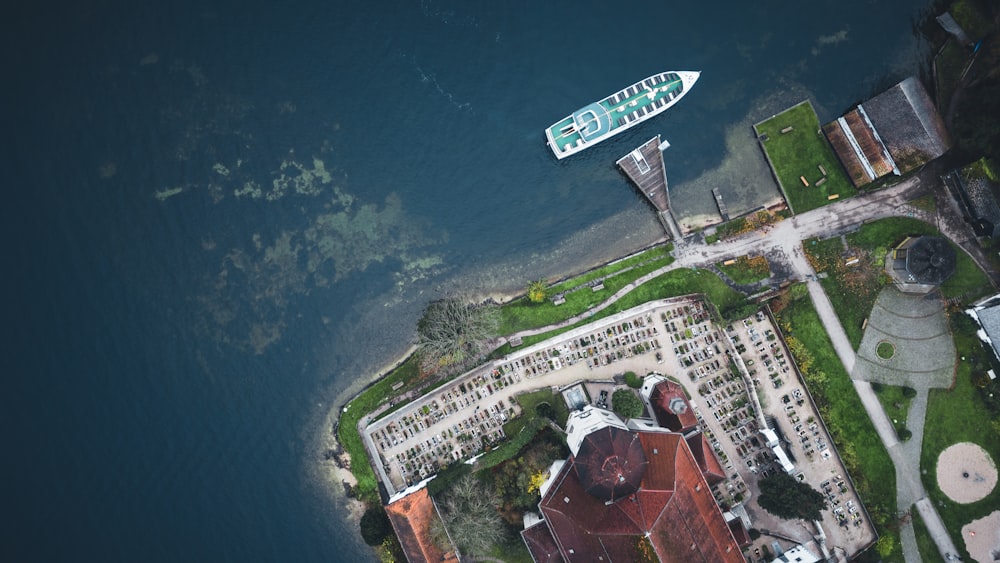 an aerial view of a city with a boat in the water