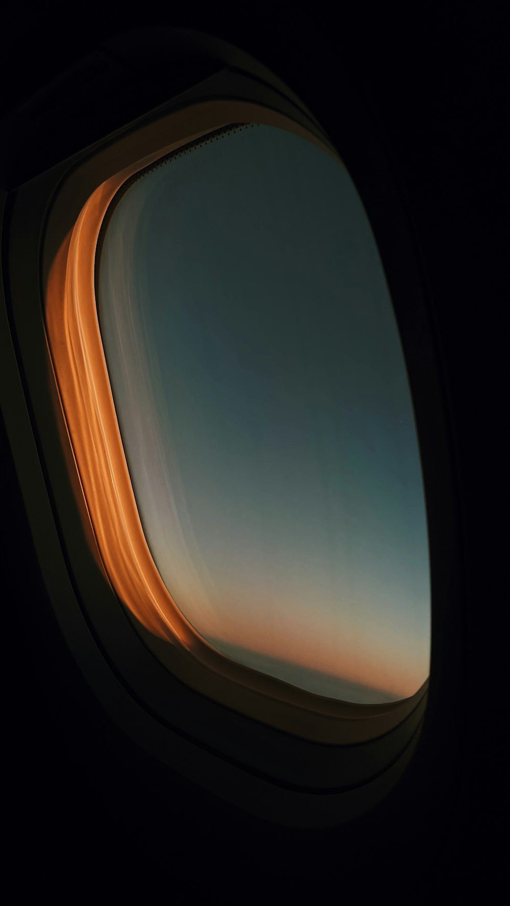 an airplane window with a view of the sky