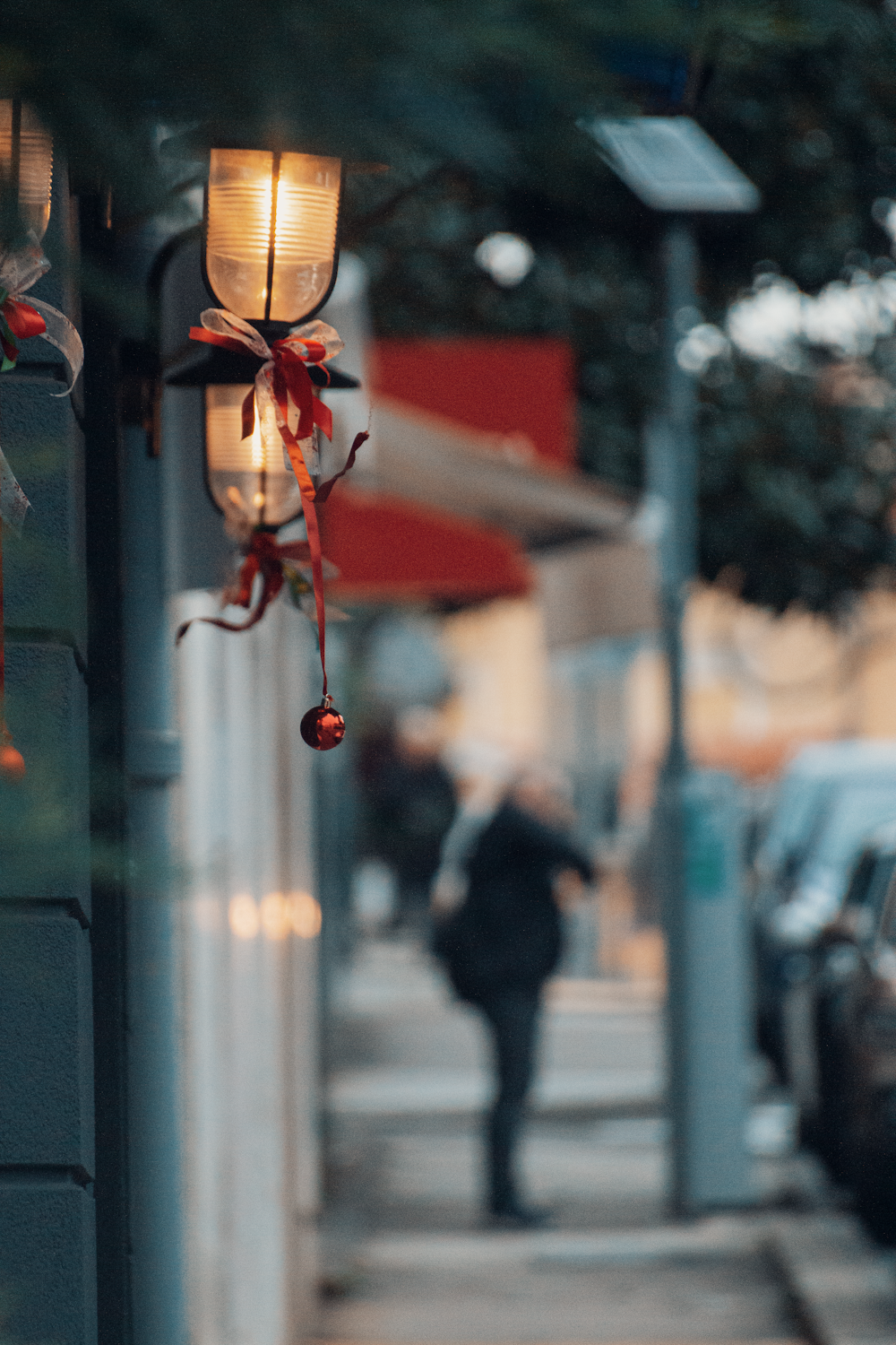 a person walking down a sidewalk next to a building