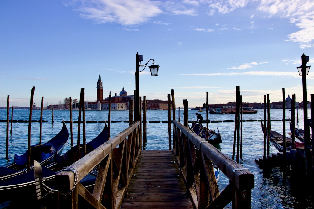 a pier with gondolas and a street light