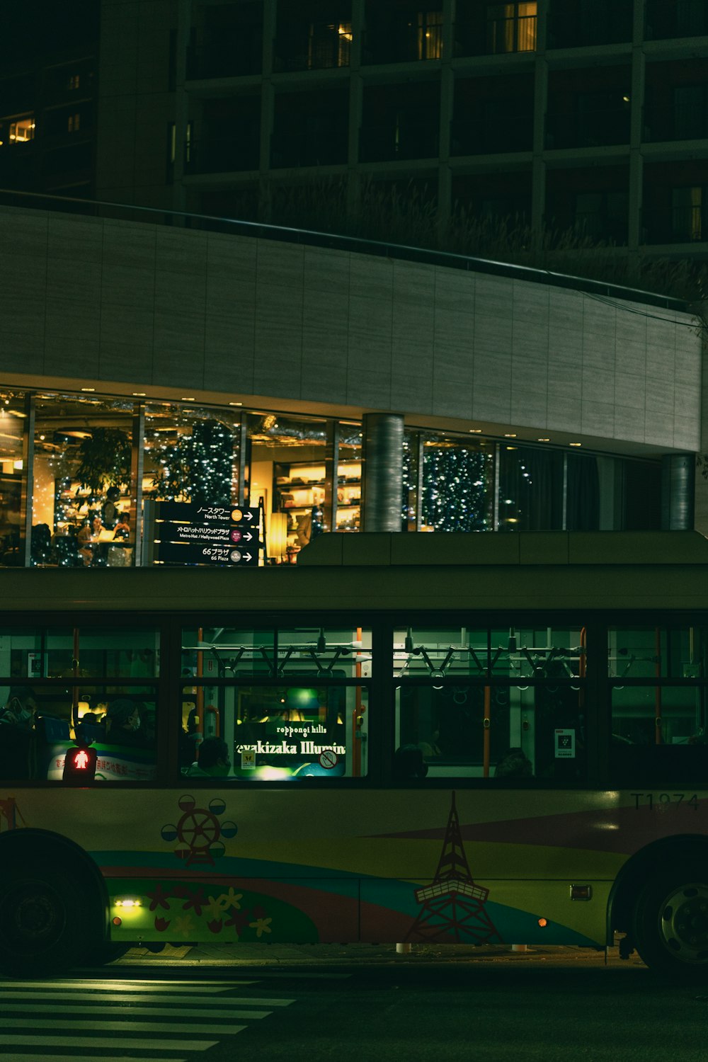 a bus parked in front of a building at night