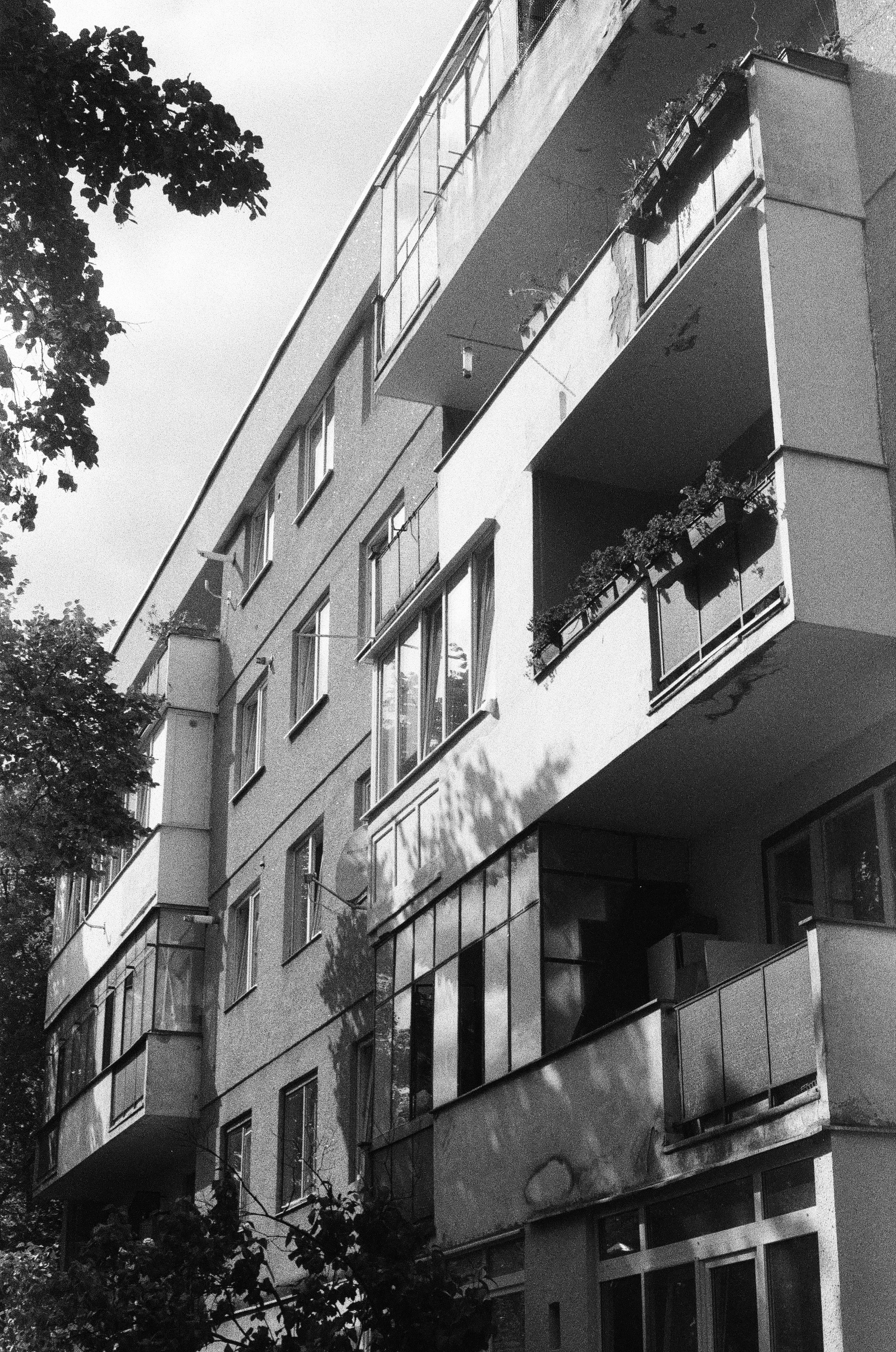 a black and white photo of a building with balconies