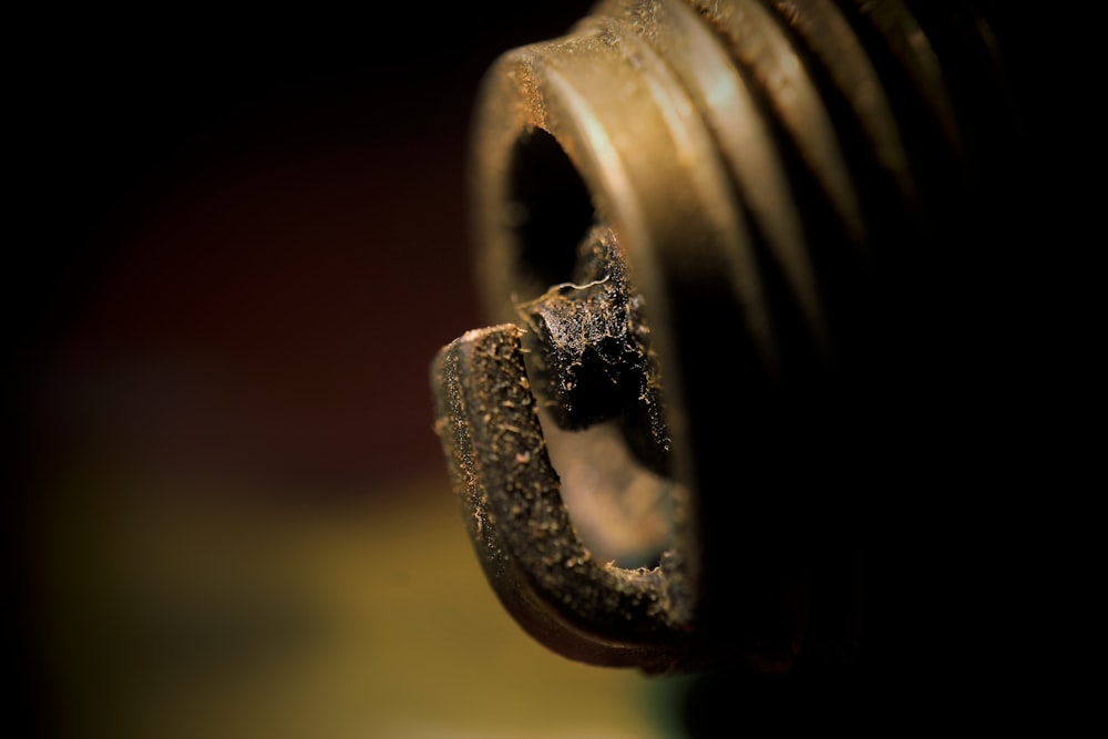 a close up of a metal object with a black background