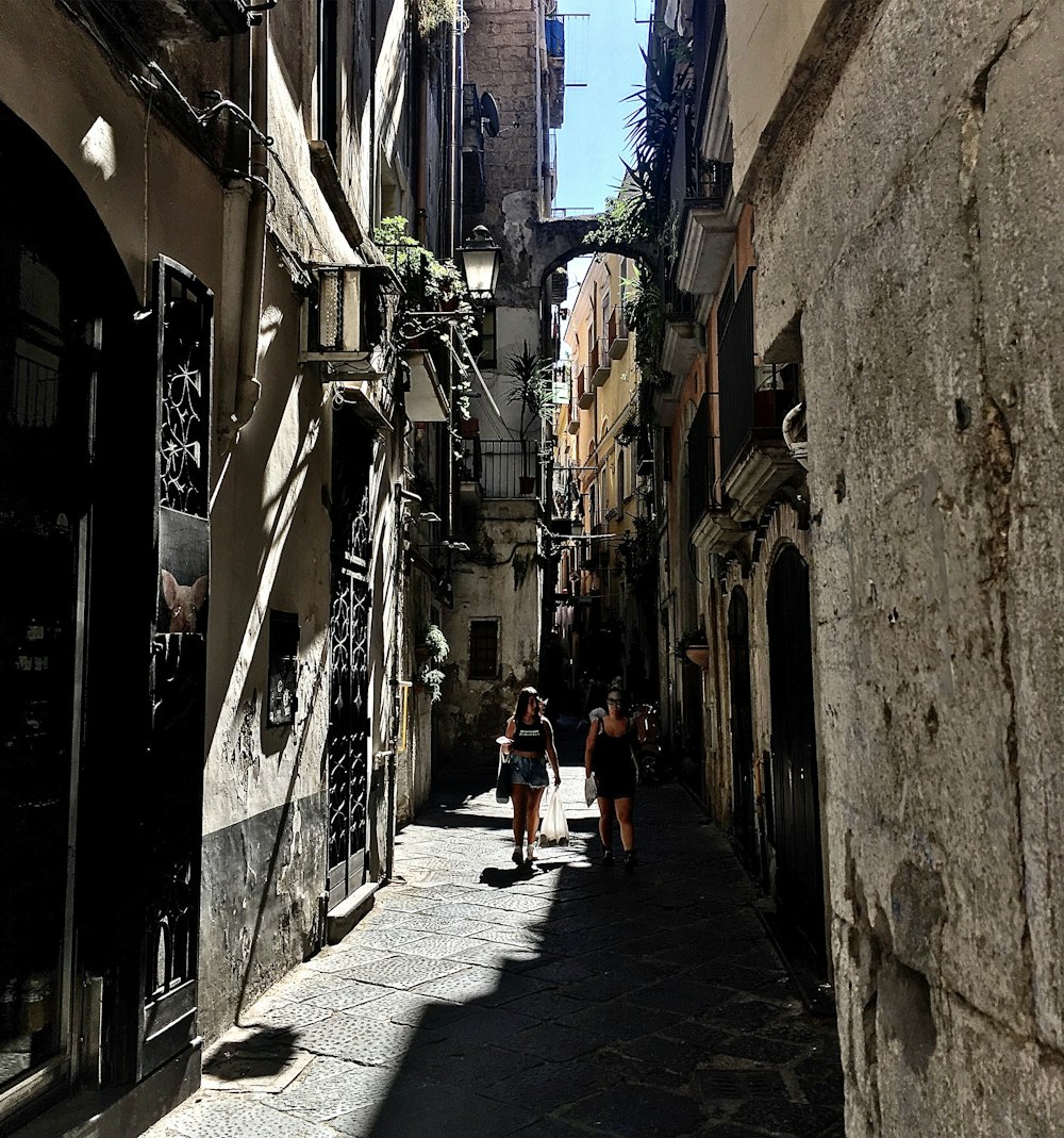 Un gruppo di persone che camminano lungo una strada accanto a edifici alti