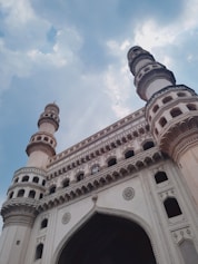a tall white building with a clock on it's side