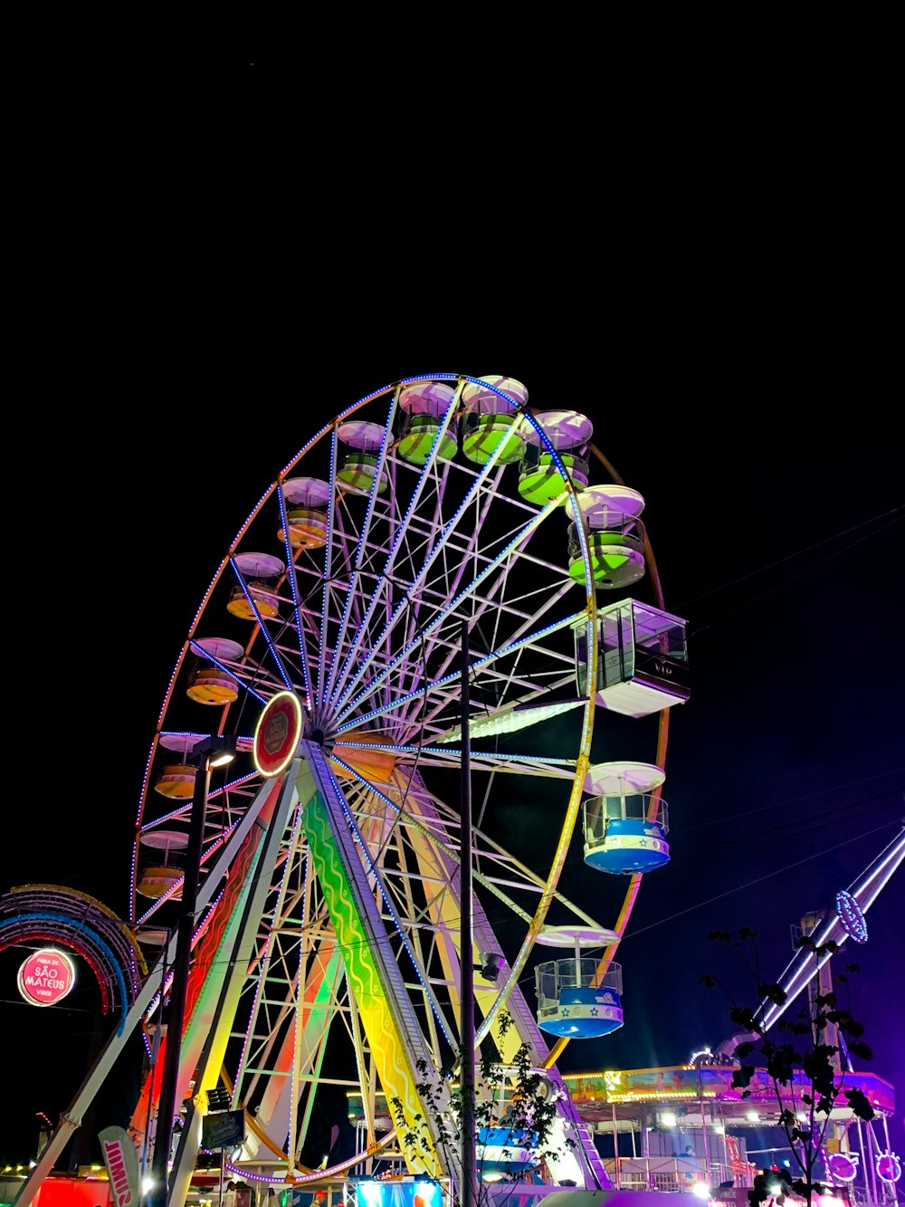 a ferris wheel is lit up at night