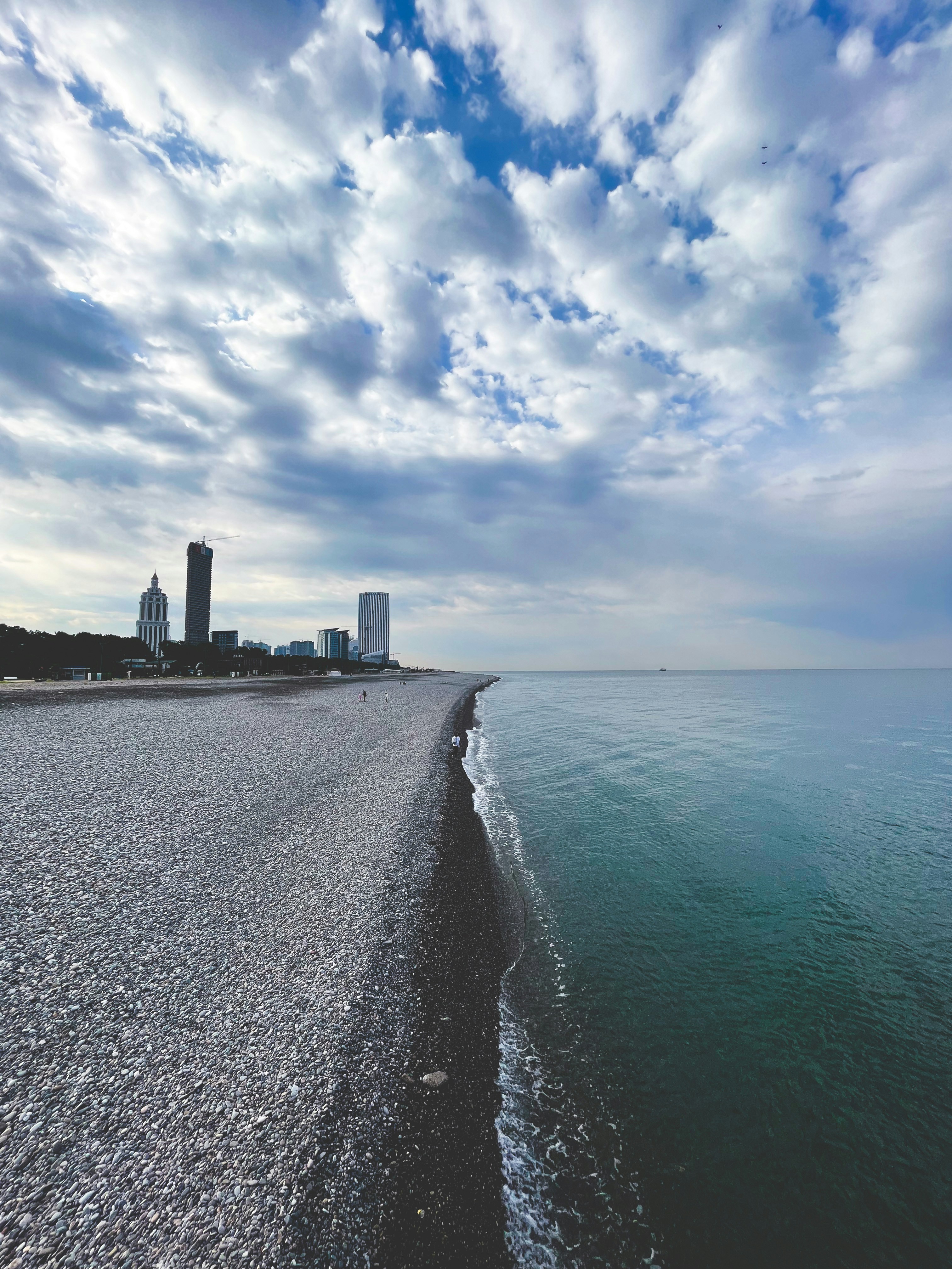 a view of a beach with buildings in the background