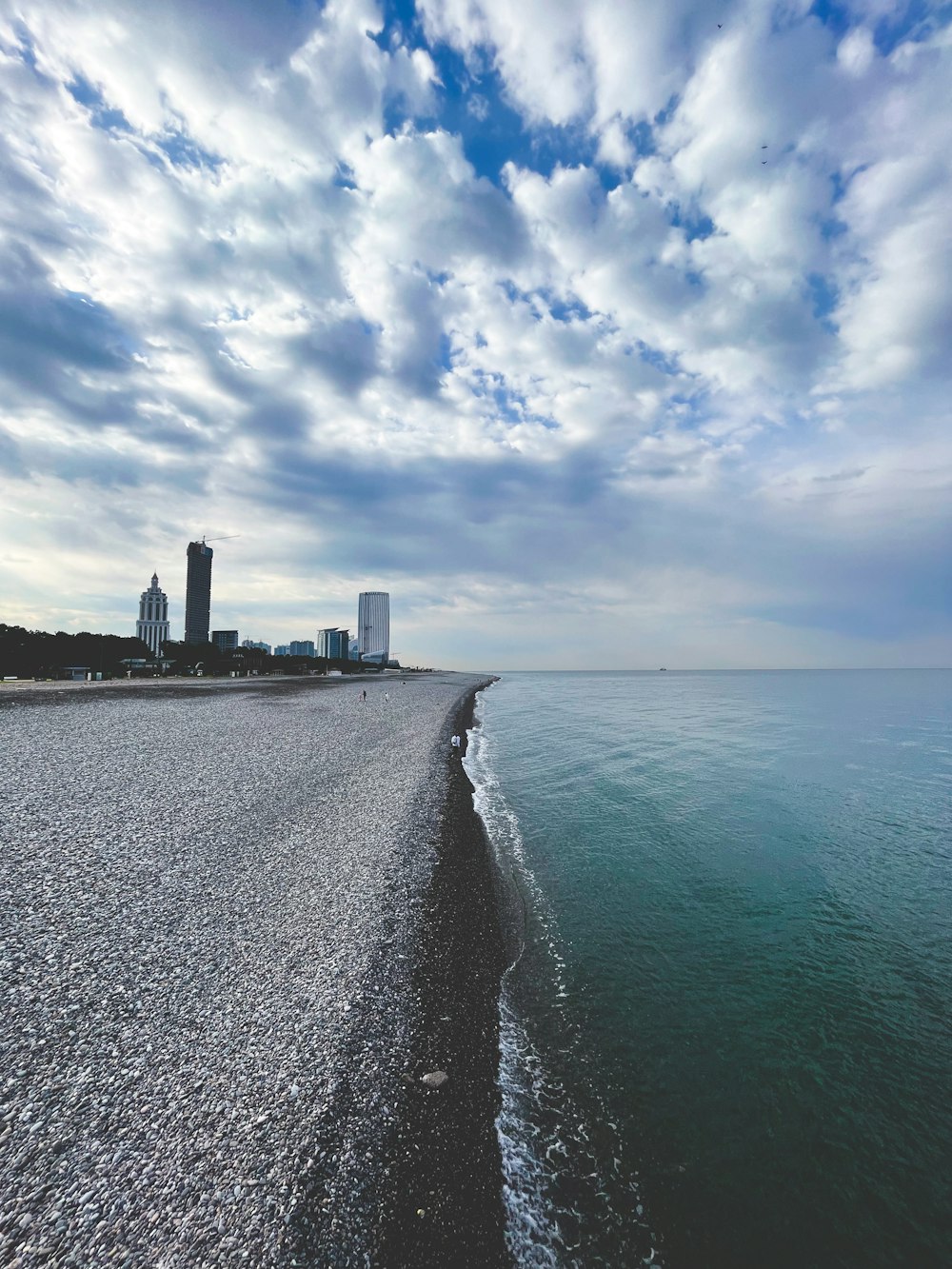 a view of a beach with buildings in the background