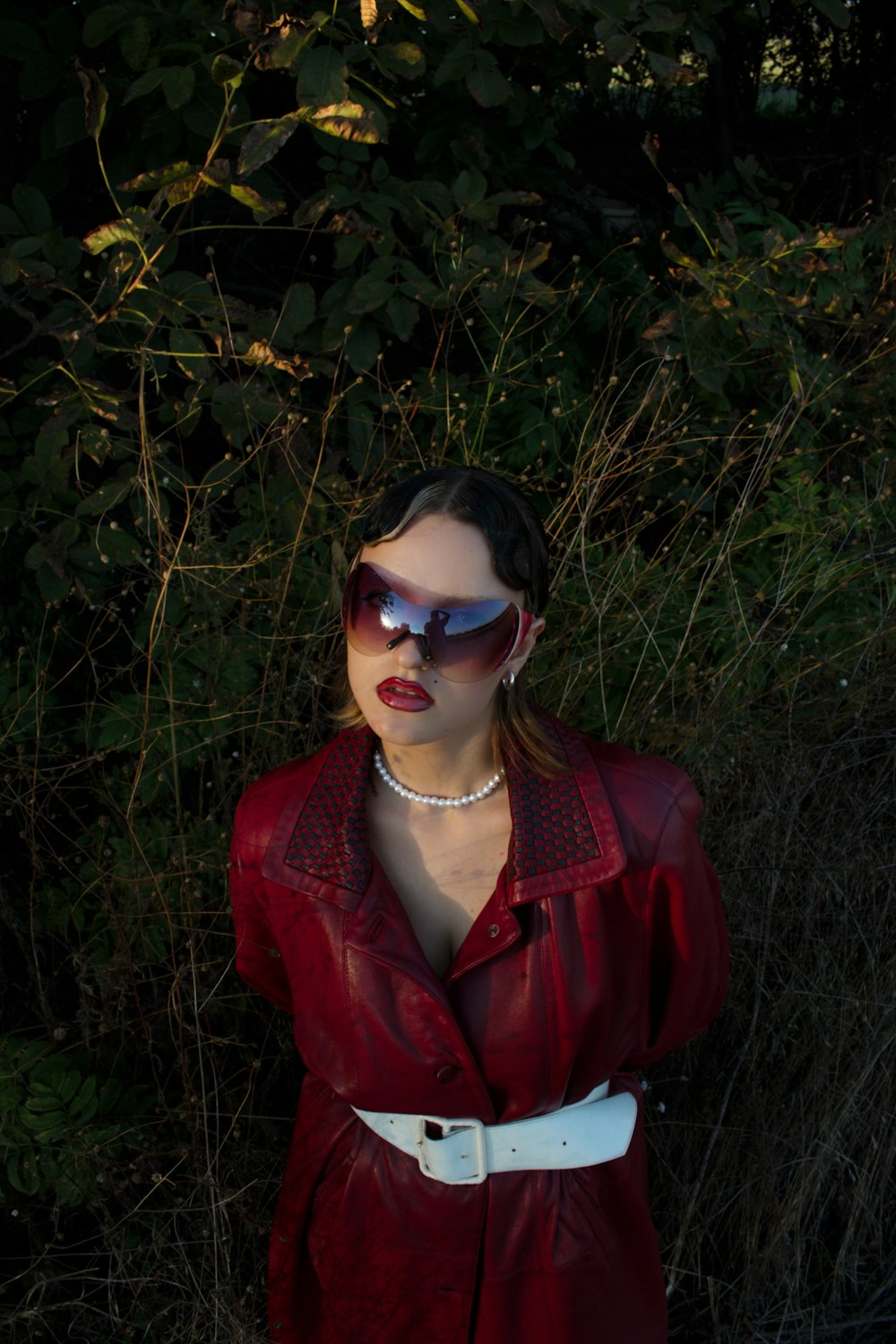 a woman wearing sunglasses and a red dress