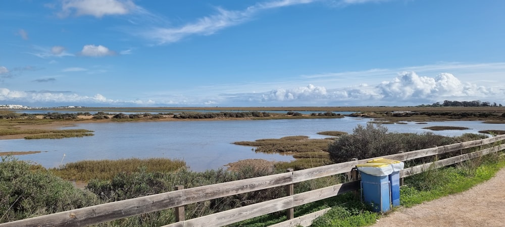 a wooden fence next to a body of water