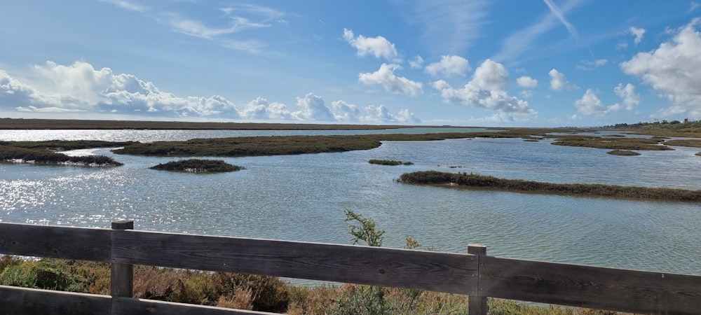 a wooden fence overlooks a body of water