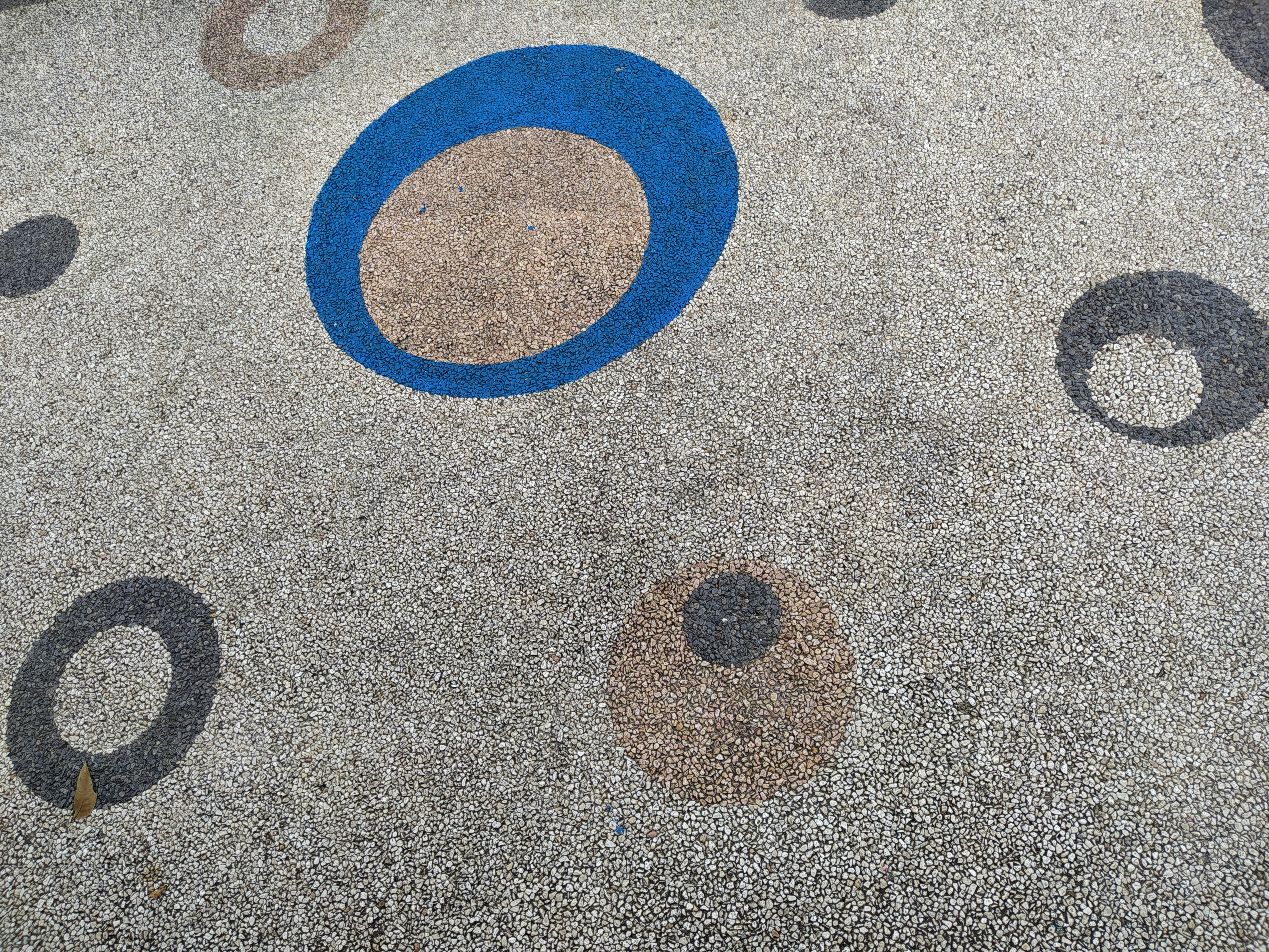 a close up of a parking lot with circles painted on it