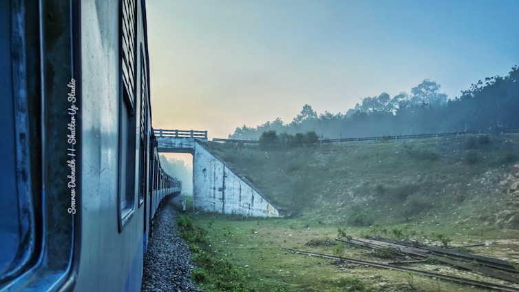 A scenic view of an Amtrak train traveling through picturesque landscapes.