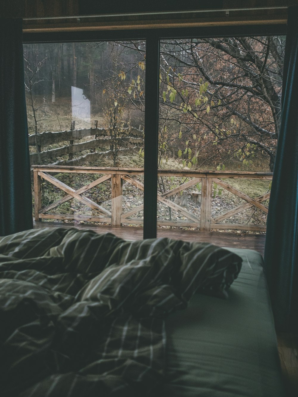 a bed in a room with a large window