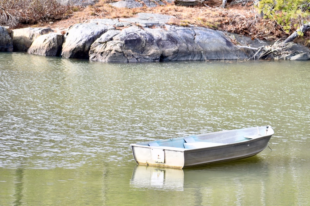 a small boat floating on top of a lake