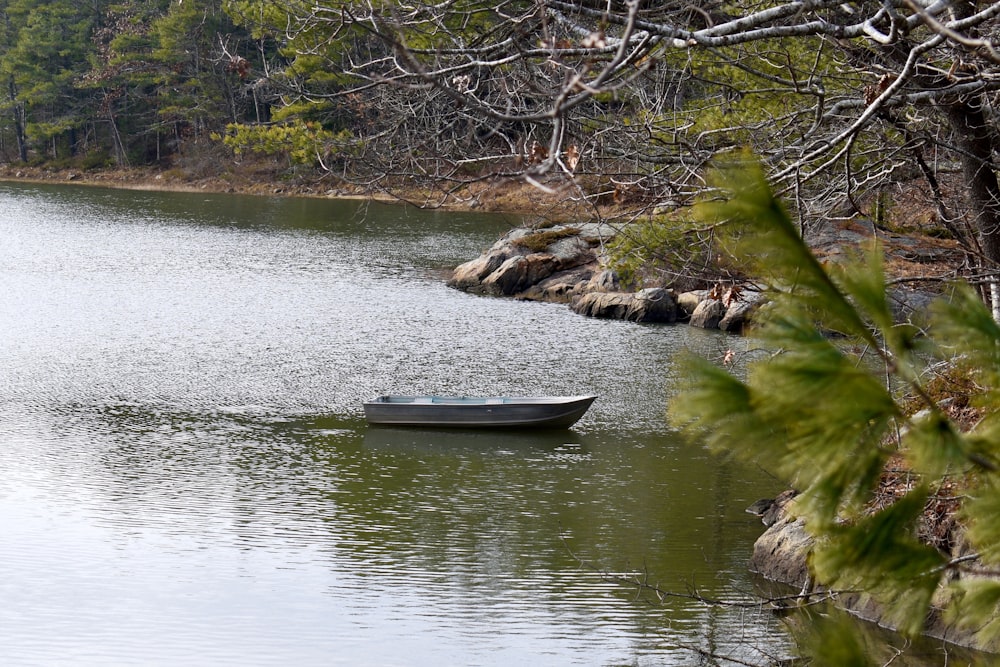 a small boat floating on top of a lake