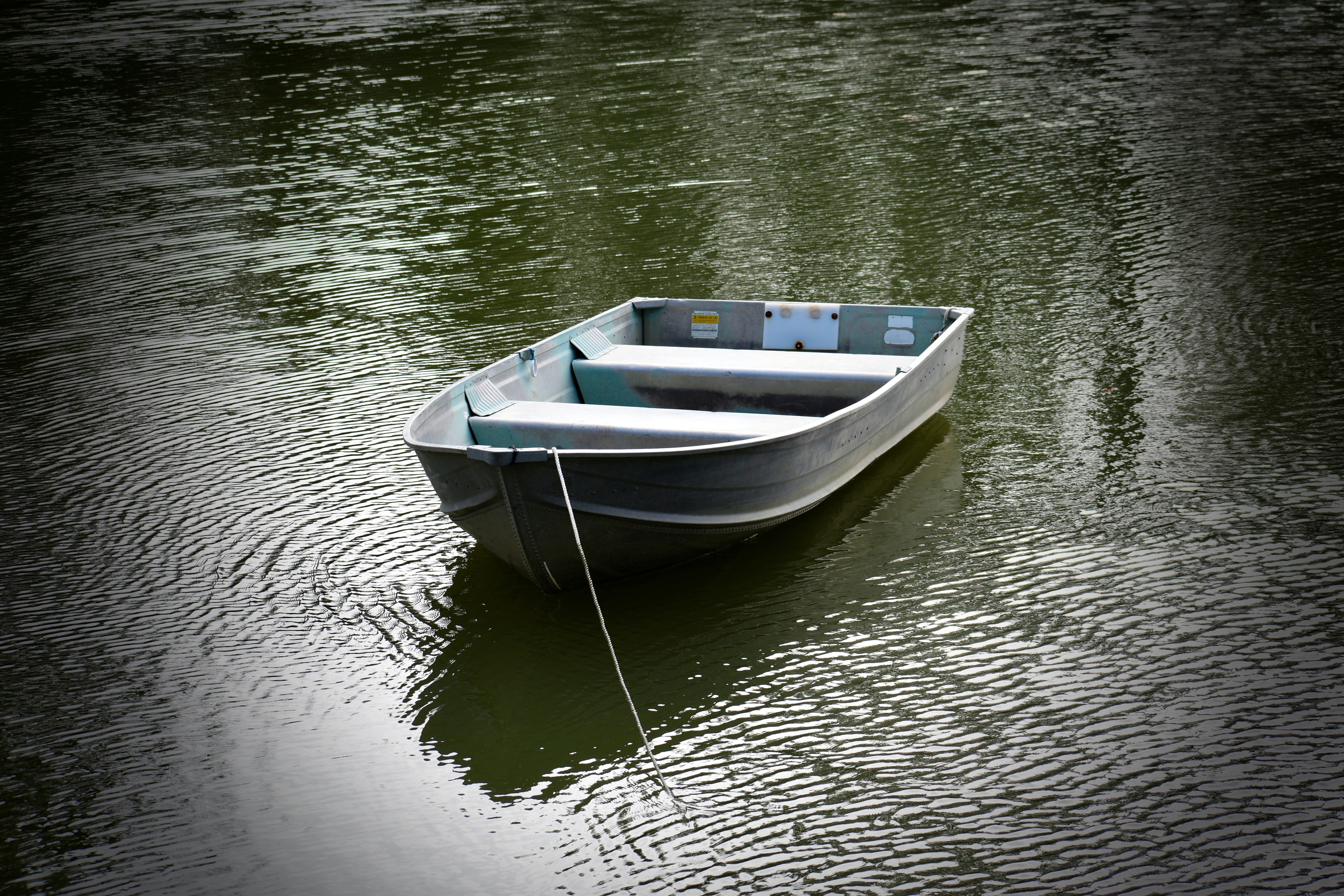 a small boat floating on top of a body of water